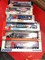 Stack of six sealed Buffalo Bills limited edition semi trucks showing packaging fronts and years 1995, 2000, 2003