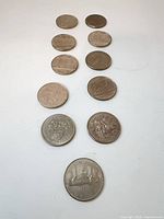 All eleven coins laid out to show fronts