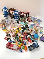 Group overview of all toys including plushes, figures, vehicles and Mighty Beanz