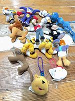 Group shot of all thirteen mini plush figures laid out on floor