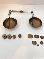 Full view of brass balance scale and all weights
