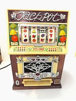 Front view of slot machine radio showing display, controls and speaker area