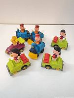 Group of six Peanuts pull-back toys on white background
