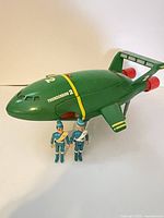 Full view of Thunderbird 2 ship with two figures in front