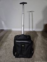 Front view of black Bugatti wheeled backpack with extended telescopic handle