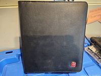 Front view of black Swiss Gear padfolio showing exterior and logo