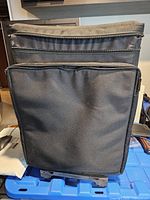 Front view of black Toshiba rolling case showing main compartments and telescopic handle slots