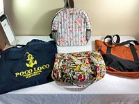 All four bags displayed on table