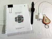 Apple Watch user guide, watch, charger, keychain displayed