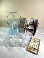 Overview of all barware items: ice bucket, six crystal glasses, OXO tool set, swizzle sticks tray