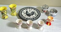 Overall lot view: plates, various egg cups, egg coddlers