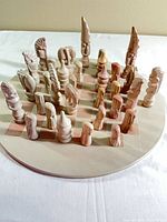 Full chess set on round board, angled view