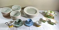 Overview of all dishware including bowls, teacups, teapot set, creamers and sugars