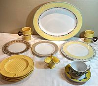 Overall view showing platter, plates, mugs, basket, cup and saucer