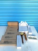 Overall lot with boxed tap handles and two unboxed samples on table