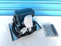 overview of carpet shearing machine on metal base with accessory pack