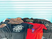 Group of eight folded/stacked Harley-Davidson t-shirts on table