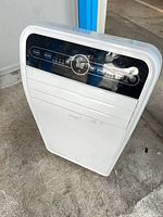 Front view of Insignia portable air conditioner showing control panel and body