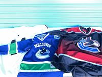 Three jerseys laid out showing front designs