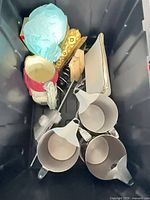 Overview of pitchers, funnels, Santa figure and other items inside black tote