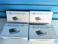Four sealed retail boxes marked Multifunction mobile phone sterilization box