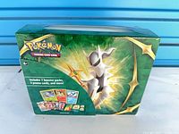 Front view of sealed Pokémon TCG box showing Arceus artwork and contents note