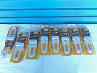 Nine sealed packages of Safety 1st cabinet locks laid out