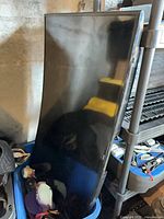 Front angled view of Samsung curved TV leaning upright