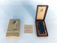 Outer sleeve, open case showing lighter, warranty card