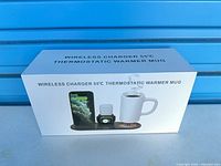 Front of sealed product box labeled "Wireless Charger 55 °C Thermostatic Warmer Mug" with product image