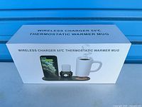 Front of sealed product box showing wireless charger 55°C thermostatic warmer mug set