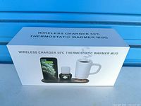 Retail box showing wireless charger and thermostatic mug warmer set