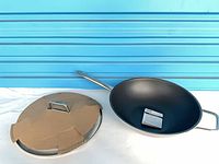 Wok with helper handle, long handle, lid with protective cardboard, booklet inside pan