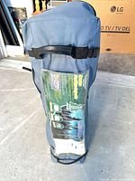 Blue carry bag standing upright showing overall condition