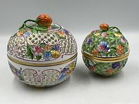 Front view of both Herend openwork lidded bowls