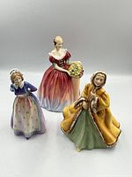 Group shot of three Royal Doulton figurines