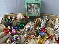 Overview of entire lot showing assorted ornaments, garlands, boxed items