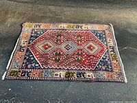 Full view of Persian rug showing design and colours