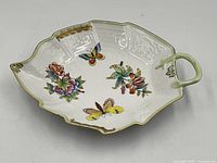 Top view of Herend Queen Victoria leaf dish showing hand-painted motif and handle
