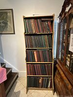 Full view of wood bookcase filled with record sets