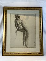 Full view of framed charcoal nude sketch in gilt frame