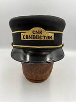 Front view showing CNR Conductor badge and visor