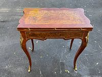 Table top closed showing marquetry and hinges