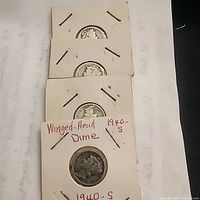 Stack of four Mercury dimes in cardboard flips, lowest marked 1940-S