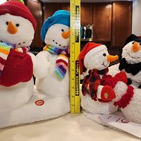 Snowmen measured with tape showing height