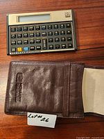 Front view of Hewlett-Packard 12C calculator and brown leather case