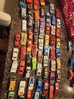 Overhead view of roughly half the diecast cars in multiple rows