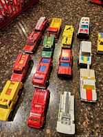 Top-down view of 16 die-cast emergency vehicles aligned on countertop