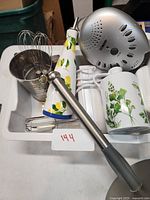 Tray with assorted kitchen utensils and Conair sound machine