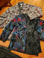 Both coats laid out showing patterns and collars
